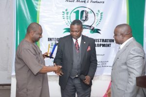 Engr. Conrad Maduagwu- one of client to Nuel mark and partners (left) receiving loyalty Award for being with the firm in the last 10yrs. ESV. (Barr) Emmanuel Mark FNIVS (lead consultant/Head of practice NMG) and the President, NIESV ESV. (Olorogun) James Omeru FNIVS watches 