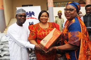 L-R: Director, Health and Nutrition, Dangote Foundation Dr. Azeez Oseni presenting  food items to the Representative of Old Peoples Home Abuja Dr. M. Ifeyinwa Obegolu, assisted is the  Representative  of the  Minister of  Federal Capital Territory, Mrs.  Elegbede Irene Adebole, when the Dangote Foundation  officially presented the food items to the needy  in Abuja - 789marketing